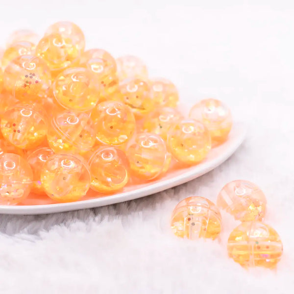 front view of a pile of 18mm Orange Glitter Acrylic Water Beads