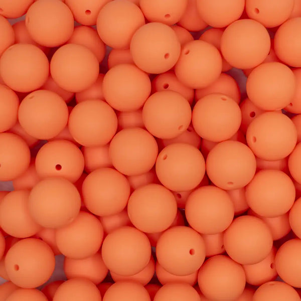 top view of a pile of 19mm Cantaloupe Orange Round Silicone Bead