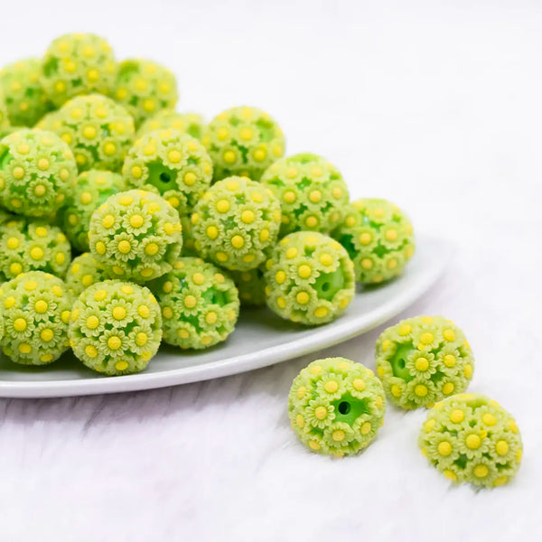 front view of a pile of 19mm Green Daisy Flower luxury bead