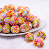 front view of a pile of 19mm Colorful Daisy Flower luxury bead