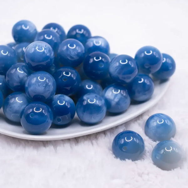 front view of a pile of 20mm Blue Color Changing Bubblegum Beads outdoors