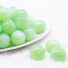 front view of a pile of 20mm green opalescence bubblegum beads