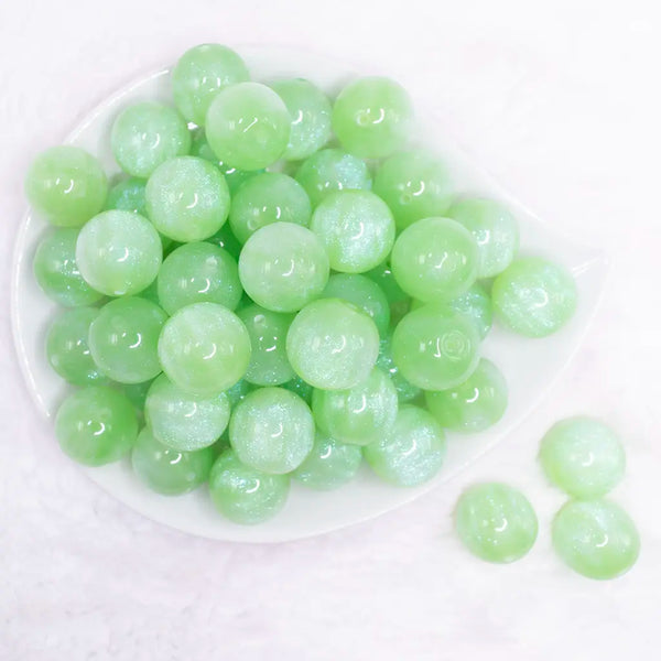 top view of a pile of 20mm green opalescence bubblegum beads