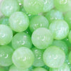 close up view of a pile of 20mm green opalescence bubblegum beads