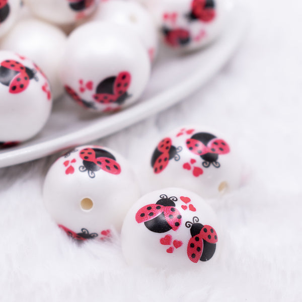 Macro view of a pile of 20mm Love Bug Print on Matte White Bubblegum Beads