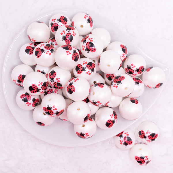 top view of a pile of 20mm Love Bug Print on Matte White Bubblegum Beads
