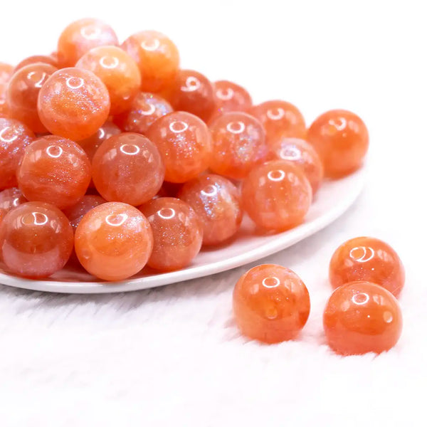 front view of a pile of 20mm Orange Opalescence Bubblegum Bead