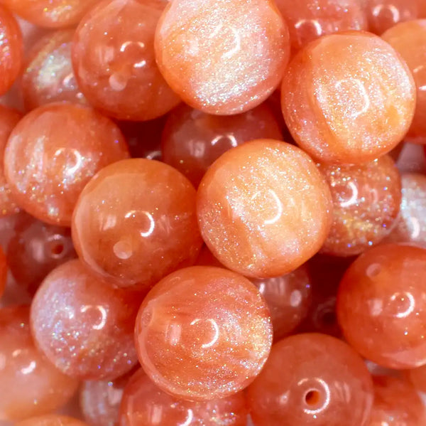 close up view of a pile of 20mm Orange Opalescence Bubblegum Bead