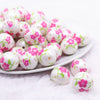 front view of a pile of 20mm Pink and Green Floral Print Bubblegum Beads