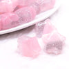 macro view of a pile of 20mm Pink Opal Star Shaped Acrylic Beads