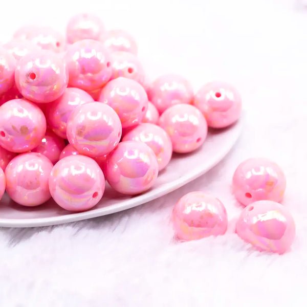 front view of a pile of 20MM Pink with Gold Foil Splatter AB Bubblegum Beads