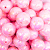 close up view of a pile of 20MM Pink with Gold Foil Splatter AB Bubblegum Beads