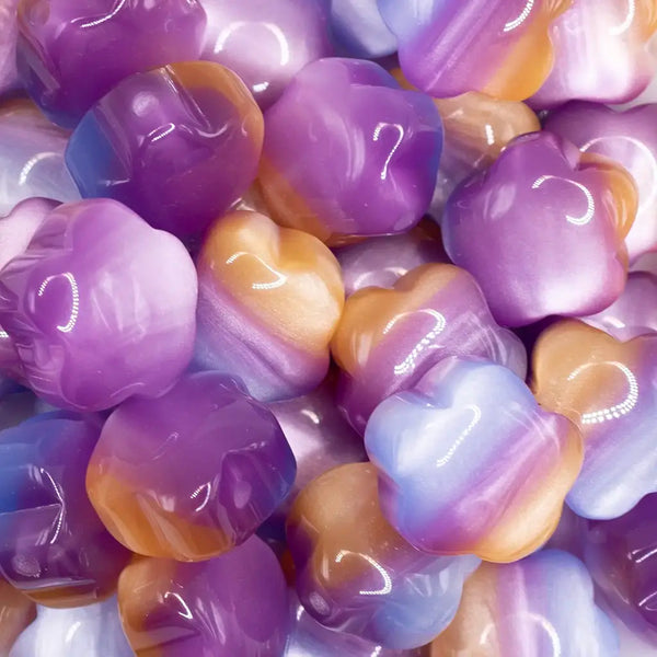 close up view of a pile of 20mm Purple Opal Flower Shaped Acrylic Beads