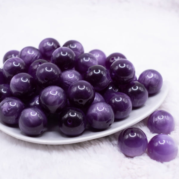 front view of a pile of 20mm Purple Color Changing Bubblegum Beads outdoors