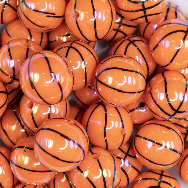 close up view of a pile of 20mm Basketball print with AB Finish Bubblegum Beads