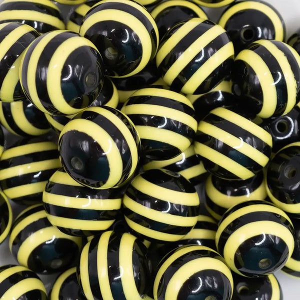 close up view of a pile of 20mm Yellow & Black Striped Chunky Bubblegum Beads