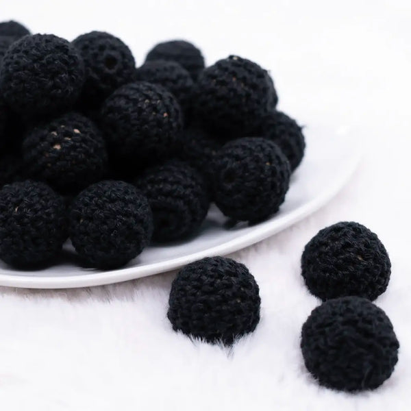 front view of a pile of 20mm Black Crochet wooden bead