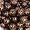 close up view of a pile of 20mm Black with Gold Filigree Printed Acrylic Bubblegum Beads
