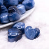 macro view of a pile of 20mm Blue Opal Heart Shaped Acrylic Beads