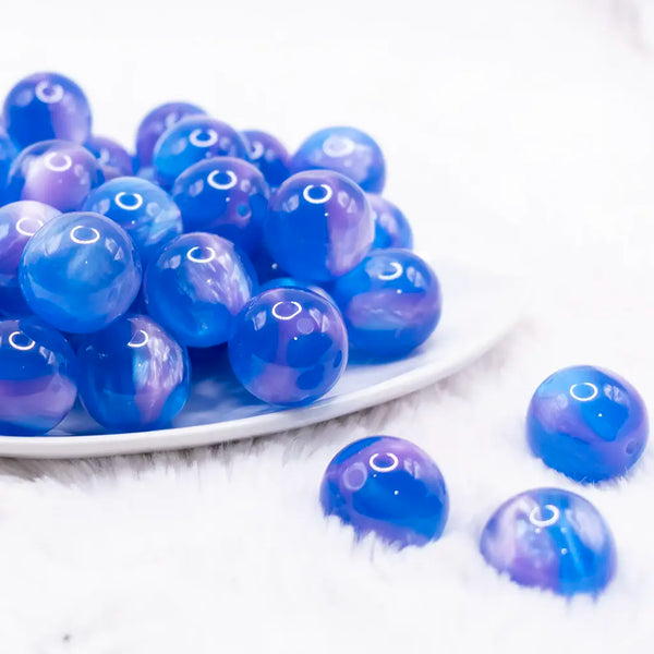 front view of a pile of 20mm Bright Blue Illusion Glitter Bubblegum Bead