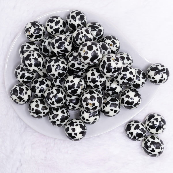 top view of a pile of 20mm Black & Cream Cow Animal Print Bubblegum Beads