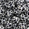 close up view of a pile of 20mm Black & Cream Cow Animal Print Bubblegum Beads