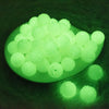 glowing view of a pile of 20mm Glow In the Dark Clear Rhinestone Bubblegum Beads