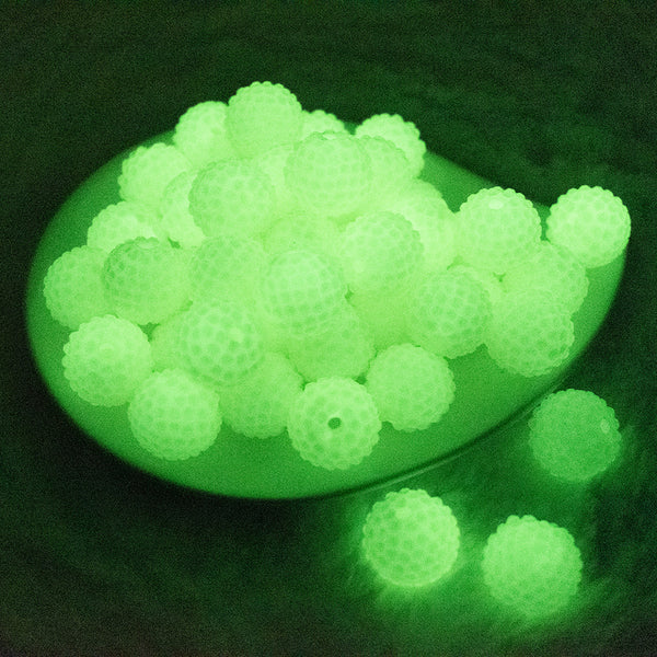 glowing view of a pile of 20mm Glow In the Dark Clear Rhinestone Bubblegum Beads