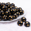front view of a pile of 20mm Gold Polka Dots on Black Acrylic Bubblegum Beads