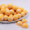 front view of a pile of 20mm Golden Yellow with White Hearts Bubblegum Beads