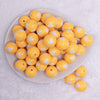 top view of a pile of 20mm Golden Yellow with White Hearts Bubblegum Beads