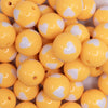 close up view of a pile of 20mm Golden Yellow with White Hearts Bubblegum Beads