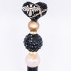 inspiration view of a pile of 20mm Black luxury acrylic beads with Gold Bee and Chain