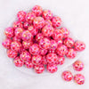 top view of a pile of 20mm Red Lips AB Print on Hot Pink bubblegum bead