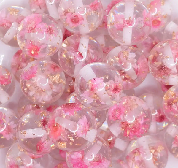 close up view of a pile of 20mm Light Pink Flaked Flower Bubblegum Bead