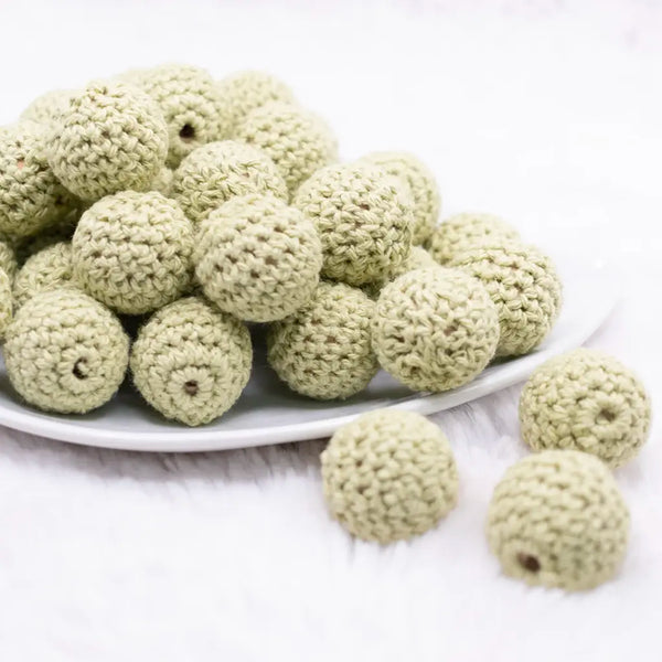 front view of a pile of 20mm matcha green Crochet wooden bead