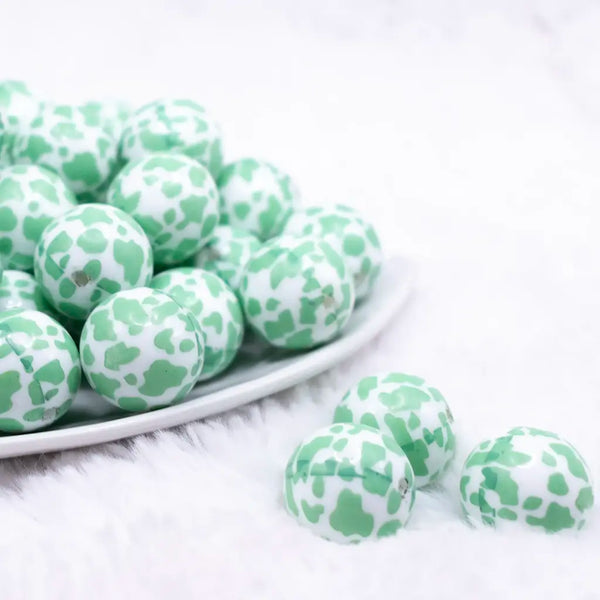 front view of a pile of 20mm Mint Green Cow Print Bubblegum Beads