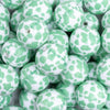 close up view of a pile of 20mm Mint Green Cow Print Bubblegum Beads