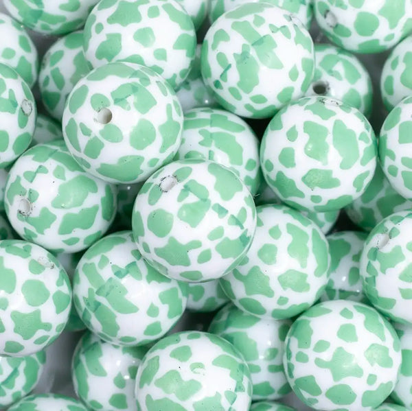 close up view of a pile of 20mm Mint Green Cow Print Bubblegum Beads