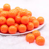 front view of a pile of 20mm Neon Orange Solid Acrylic Bubblegum Beads