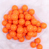top view of a pile of 20mm Neon Orange Solid Acrylic Bubblegum Beads