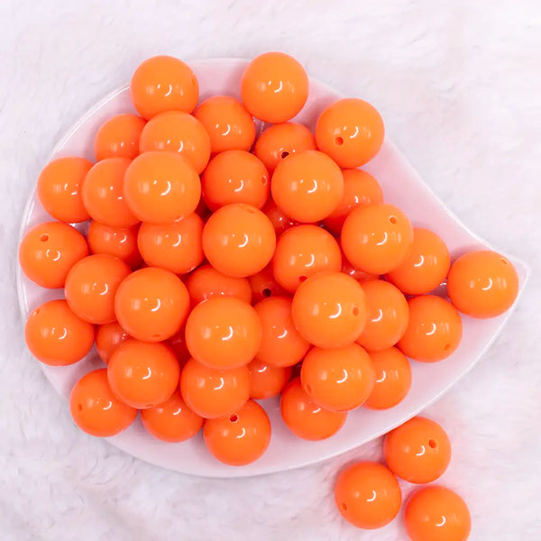 top view of a pile of 20mm Neon Orange Solid Acrylic Bubblegum Beads