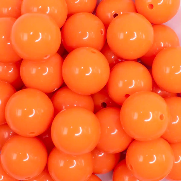 close up view of a pile of 20mm Neon Orange Solid Acrylic Bubblegum Beads