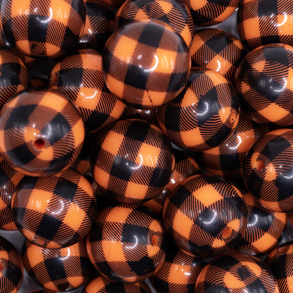 close up view of a pile of 20mm Orange and Black Plaid Bubblegum Beads