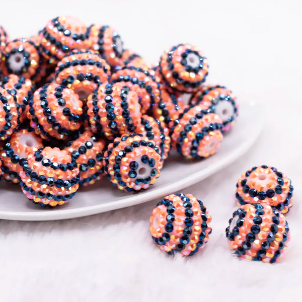 front view of a pile of 20mm Orange and Black Striped Rhinestone Bubblegum Beads