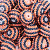 close up view of a pile of 20mm Orange and Black Striped Rhinestone Bubblegum Beads