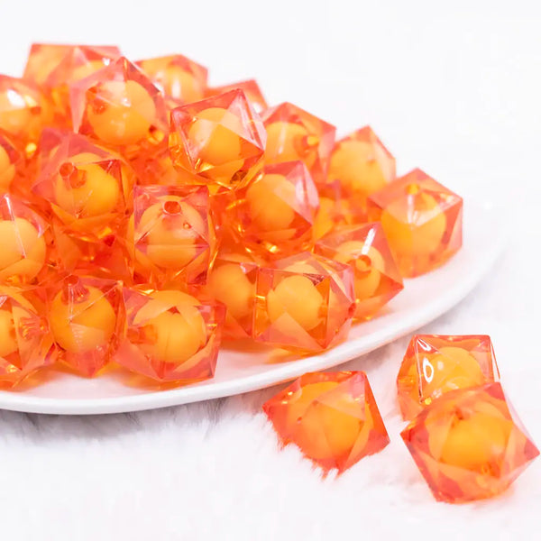 front view of a pile of 20mm Orange Transparent Cube with Middle Bubblegum Beads