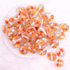 top view of a pile of 20mm Orange Flaked Flower Bubblegum Bead