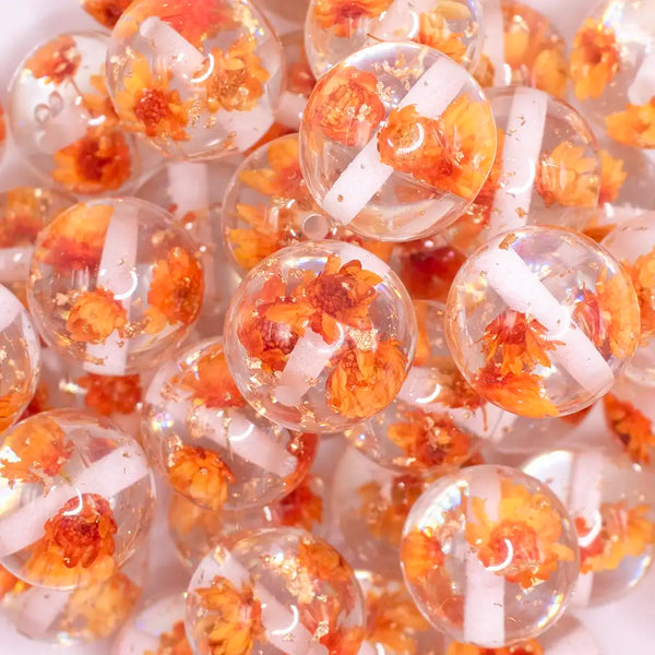 close up view of a pile of 20mm Orange Flaked Flower Bubblegum Bead
