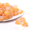 front view of a pile of 20mm Orange Opal Star Shaped Acrylic Beads